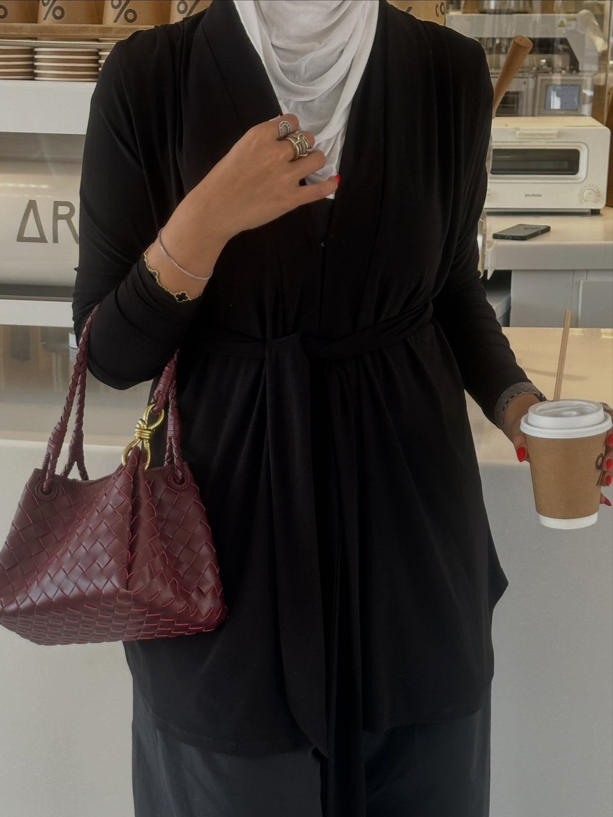 Black cardigan with front belt.